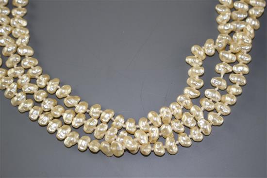 A double strand cultured baroque pearl necklace with yellow metal and garnet ? cluster clasp and one other simulated pearl necklace.